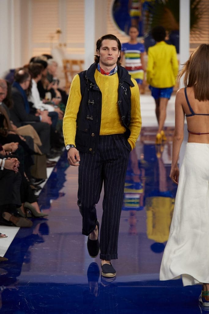 Ralph Lauren navy cotton and nylon vest,yellow cashmere cable sweater, navy and white linen pinstripe pant, red, yellow, blue and white silk scarf, navy canvas espadrille.