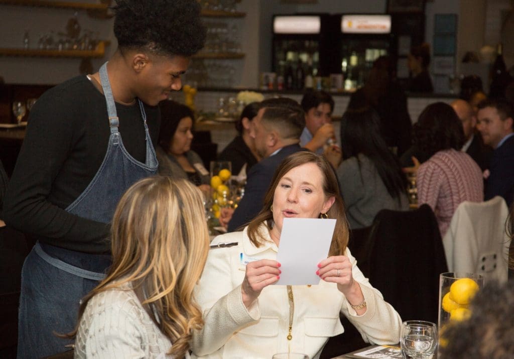A BBVA Compass guest places her order with a Café Momentum intern.