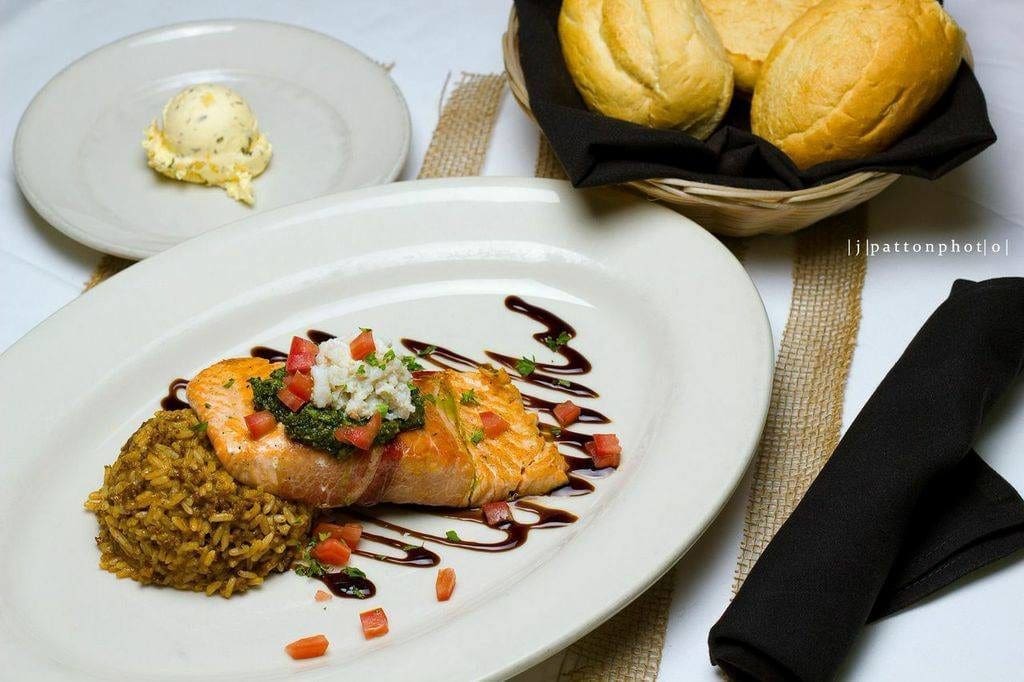 French Quarter Grille brings cajun comfort to seafood, like this proscuitto-wrapped and grilled French Quarter Salmon. (Photo by French Quarter Grille.)