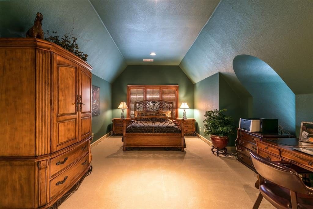 The home's fourth bedroom boasts a vaulted ceiling and two dormer windows with stained wood plantation shutters. 
