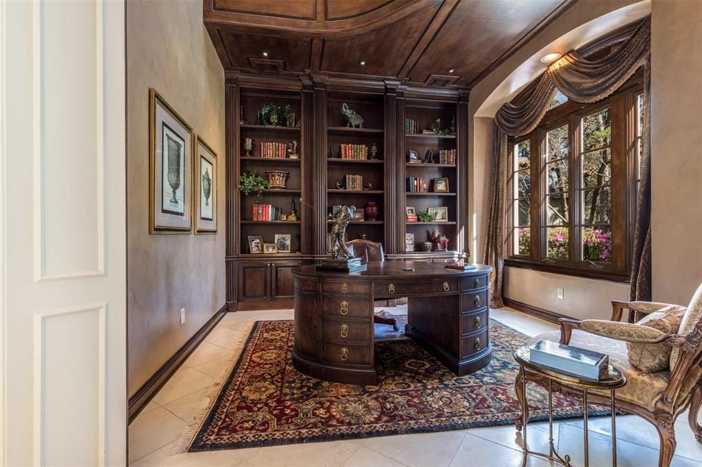 The first floor study features stained wood built-in bookcases with cabinets and adjustable shelves. 