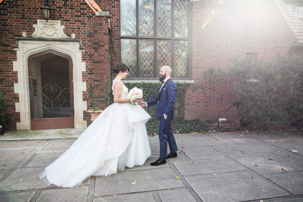 Bivins and Cone share a moment outside the church where they both attended school. Cone wears a custom Harper & Jones tuxedo (Photo by Samuel Lippke Studios)