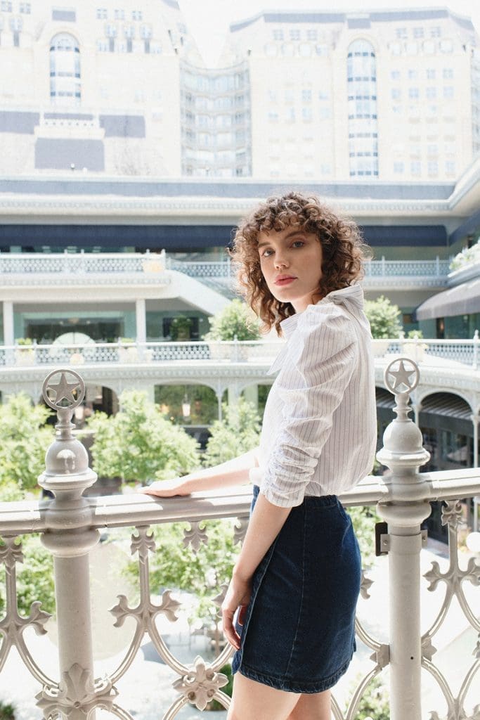 Dress up a denim skirt with a frilly blouse. 