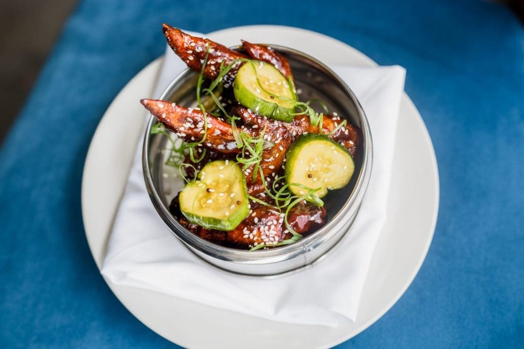 Spicy chicken wings, which are air dried for a crisper texture then served in house-made Sama Sama sauce with Bread & Butter pickles 