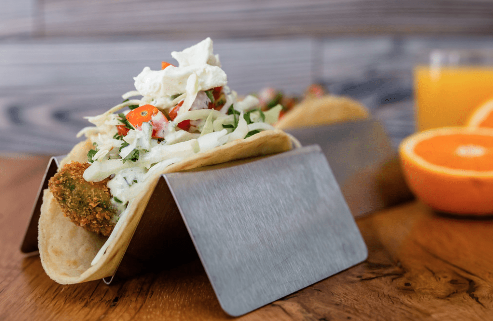This fried avocado taco is sprinkled with Mexican cheese.