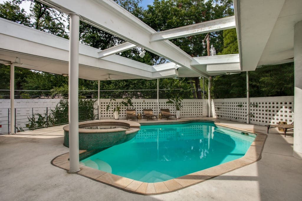 A pool and hot tub complete the backyard. 