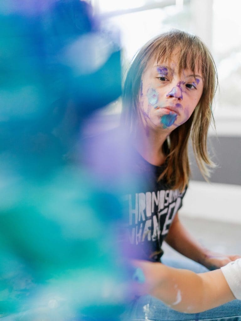 Sevy isn't afraid to get down and dirty when she paints. (Photo Bailey Hart)