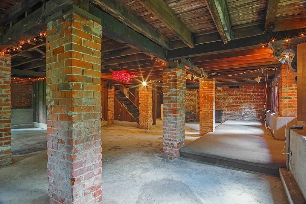 The vast basement is full of exposed brick. 