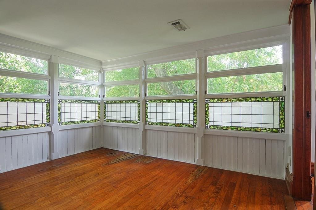 Stained glass windows add to the allure of the sun room off the kitchen. 