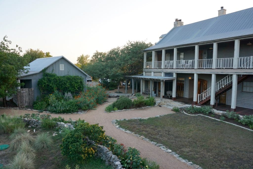 To the left is the garden spa and vegetable garden; to the right is the main farmhouse. 