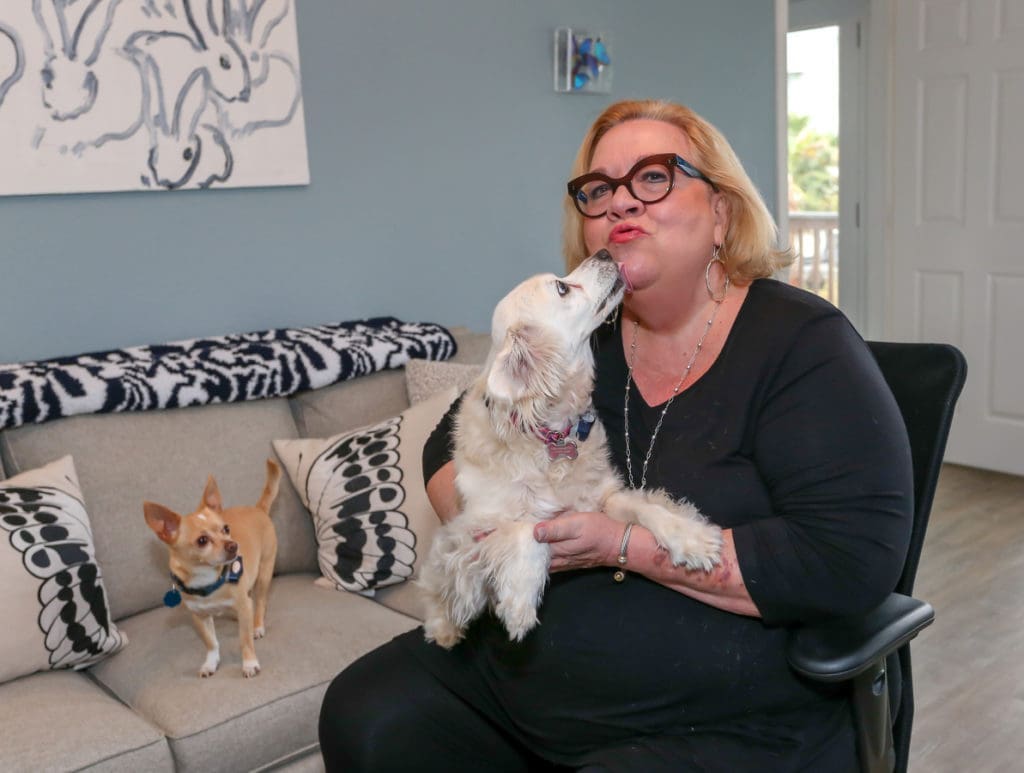 Marilyn Monroe gives her mom, Jayne Edison, a kiss under Hunt Slonem's "Bunnies" while Antonio Banderas looks on. Slonem's "Bunnies" are for good luck, Edison says. Edison sits in a Kimball Itsa chair.