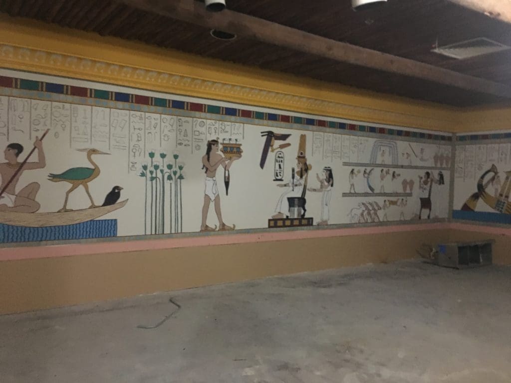 A painter is restoring each mural in Magic Island. 