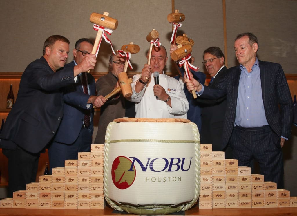 HOUSTON, TX - OCTOBER 18:  Nobu Founders Robert De Niro, Chef Nobu Matsuhisa, Meir Teper and friends break open a 5-gallon sake barrel at the Nobu Houston Sake Ceremony on October 18, 2018 in Houston, Texas.  (Photo by Rick Kern/Getty Images for Nobu)