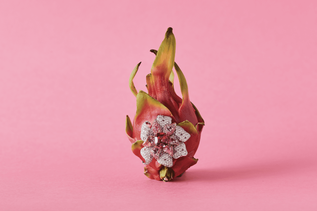 Orchid brooch with rare pink spinel center surrounded by multi coloured sapphire and diamonds in 18 karat white gold