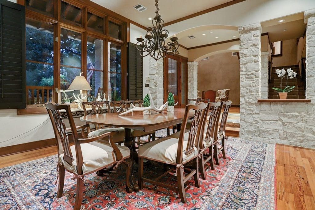 The dining room is spacious and faces windows with views of the wooded neighborhood. 