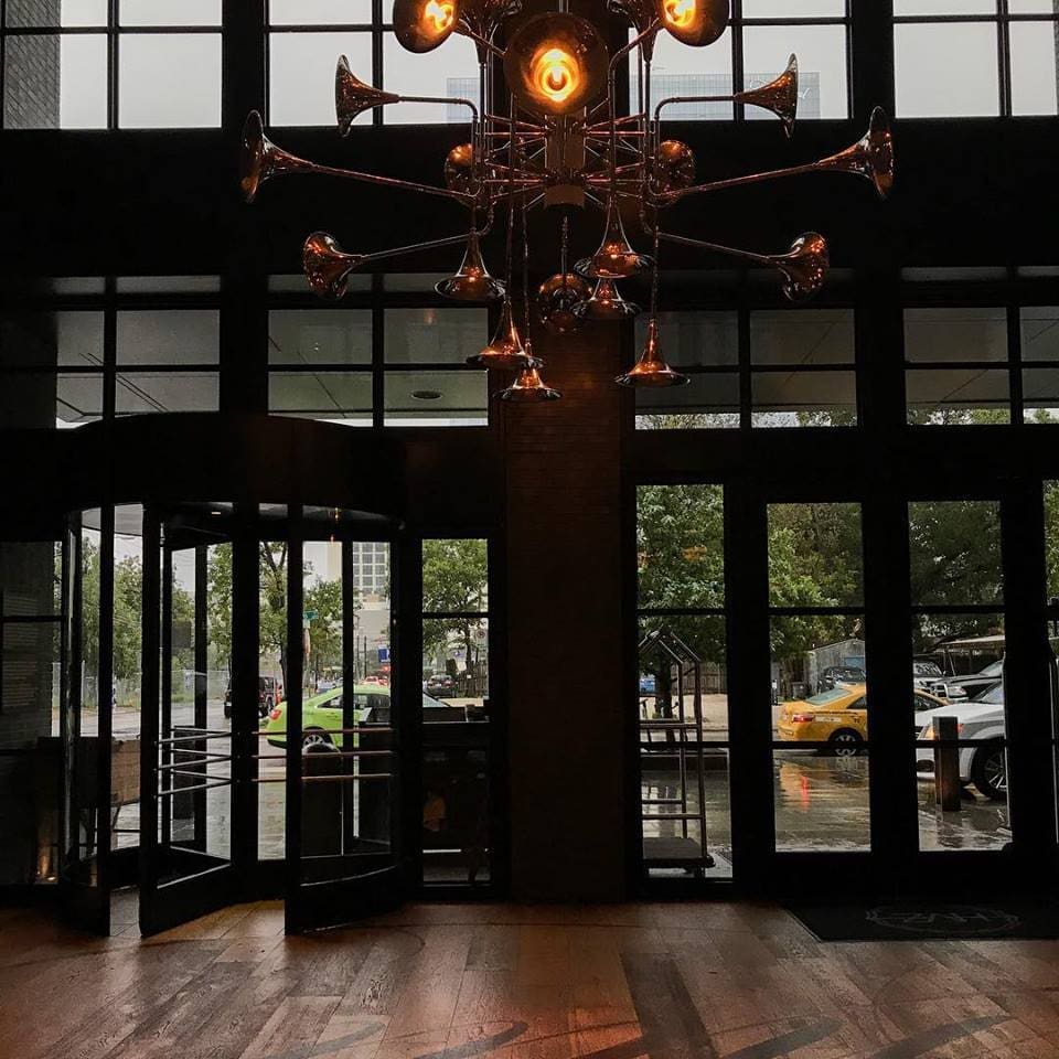 Artists created trumpet chandeliers for Kimpton Hotel Van Zandt. 