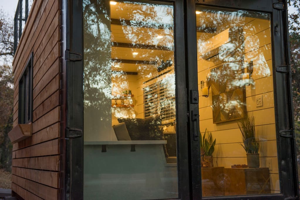 This innovative container home near Magnolia sleeps two people in a surprising custom Murphy bed. 