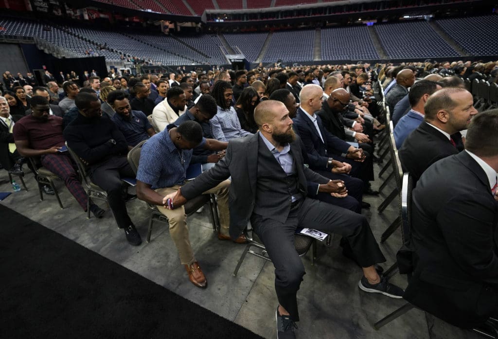 Houston Texans players pray during a public celebration of life for Houston Texans owner Robert C. McNair at NRG Stadium. (AP Photo/David J. Phillip, Pool)