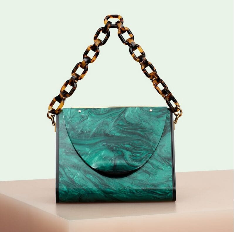 Yule-time lucite: An ode to '50s and '60s glamour, American brand Edie Parker has revived this lost look, with sculptural acrylic handbags that are both polished and precise. Triangle bag in emerald, $1,495, through Edie Parker. (edie-parker.com) 