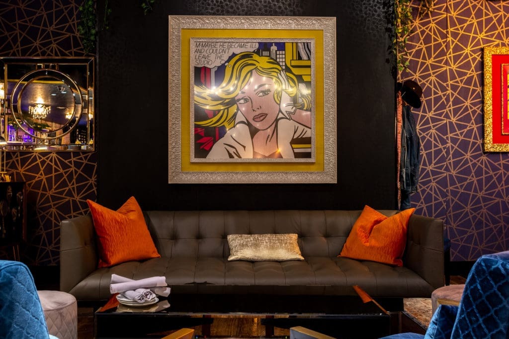 A pop of Pop Art presiding over couch seating