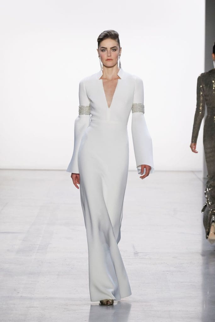 Badgley Misckha white gown with silver arm trim (Photo by Badgley Mischka)