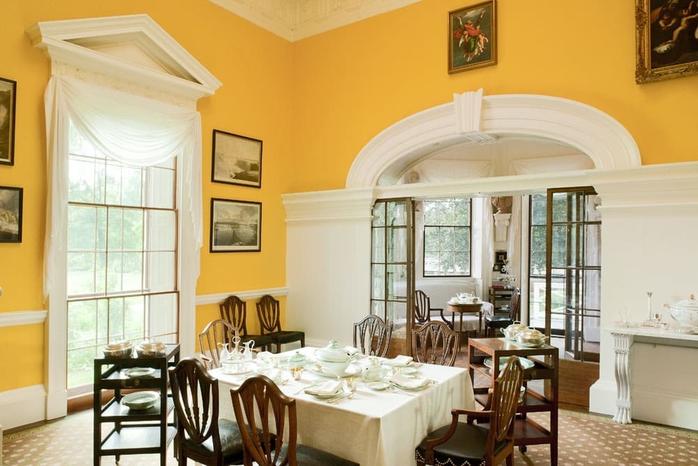 Monticello Dining Room. The dining room walls at Monticello are currently painted "chrome yellow," a color recreated through paint analysis studies. The room features two sets of window sashes, double pocket doors on rollers, a skylight, a wine dumbwaiter, and a revolving serving door. Photo by Philip Beaurline, courtesy Thomas Jefferson Foundation at Monticello.