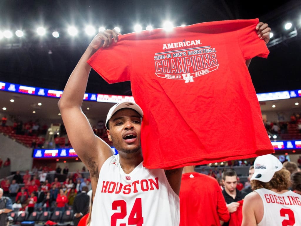 University of Houston forward Breaon Brady holds up one of the championship T-shirts. (Photo by F. Carter Smith)