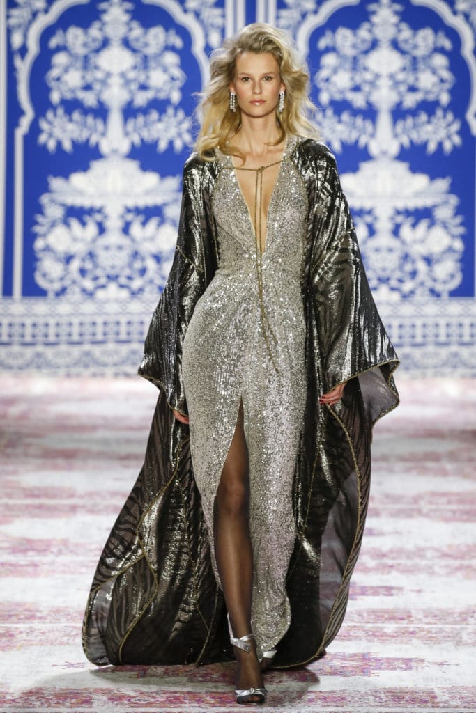 Naeem Khan long-sleeve silver stretch sequin gown with deep V neck and striped charcoal lame cape. (Photo by Naeem Khan)