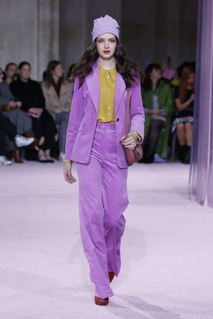 Kat Spade New York pink corduroy pantsuit, marigold blouse, lavender turban. (Photo by Kate Spade New York)