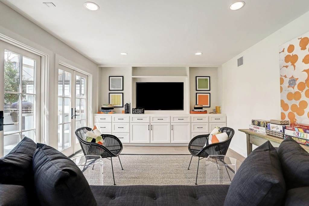The gameroom features an entertainment center and access to the backyard.