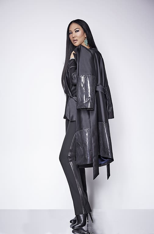 Kimora Lee Simmons models a striped tuxedo pant, gray blouse, and coat with shiny panels from her fall Kimora Lee Simmons collection. (Photo by Kimora Lee Simmons)