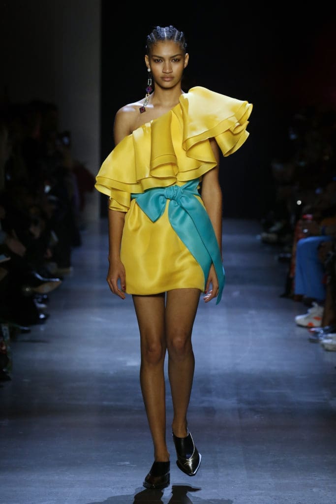 Prabal Gurung marigold silk gazar dress with hand-draped off-the-shoulder flounce and turquoise silk gazar sash. (Photo by Prabal Gurung)
