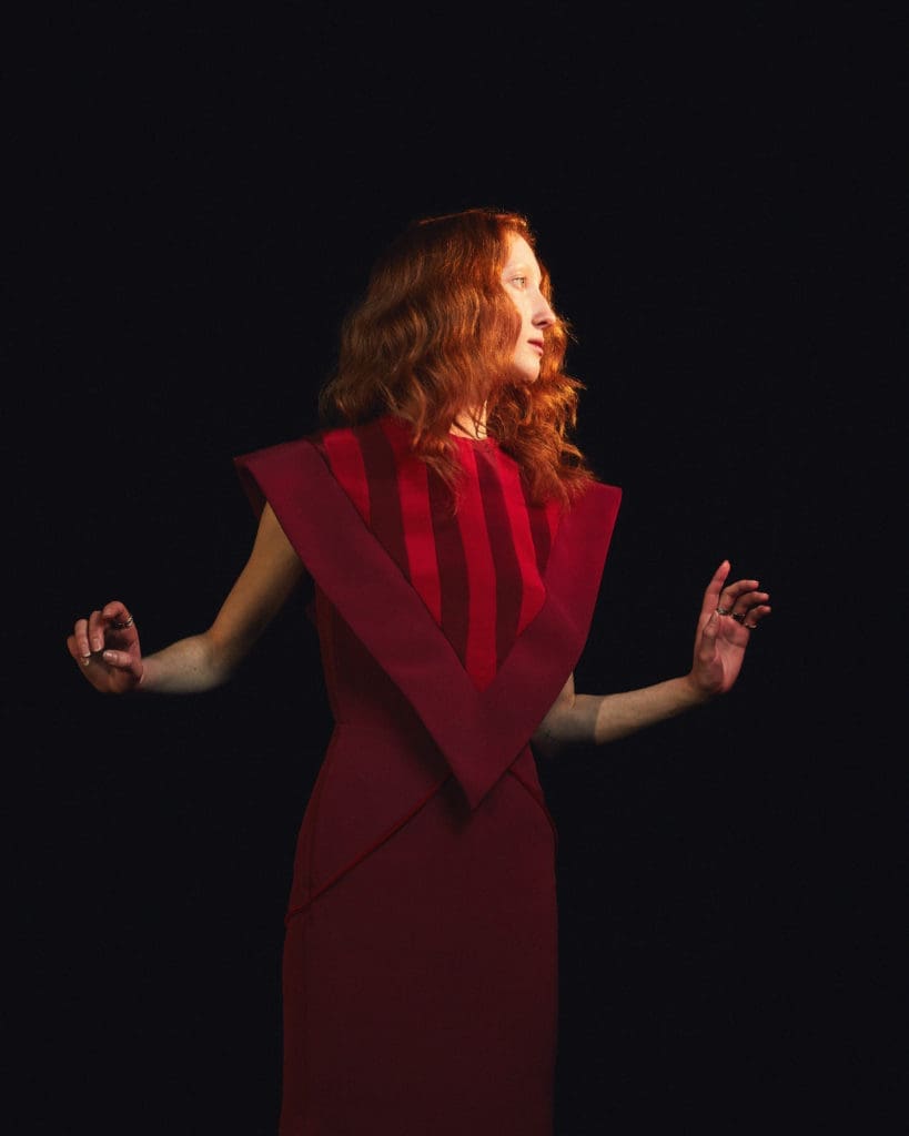 Amir Taghi burgundy dress with inverted striped triangle detail. (Photo by Amir Taghi)