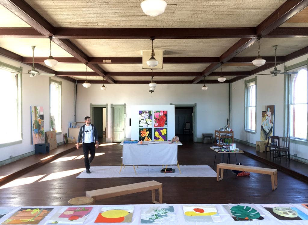 Artist-in-residence Bradley Kerl preparing for open studios at 100 West, Corsicana, Texas. The vast space was originally an Odd Fellows Lodge; the historic building has occupied a prime corner of this Texas hamlet, population 23,000, for 121 years. (Photo by Kyle Hobratschk)