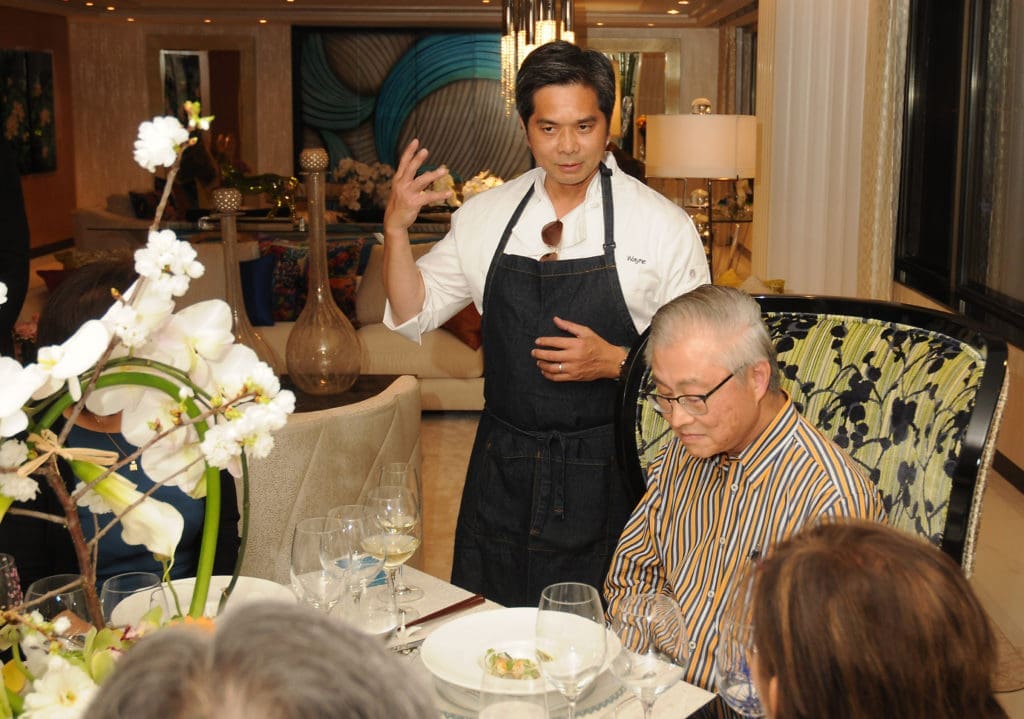 Chef Wayne Nguyen explains his dish as Dr. Peter Chang anticipates the dish at the KNOWAutism dinner. (Photo by Dave Rossman)