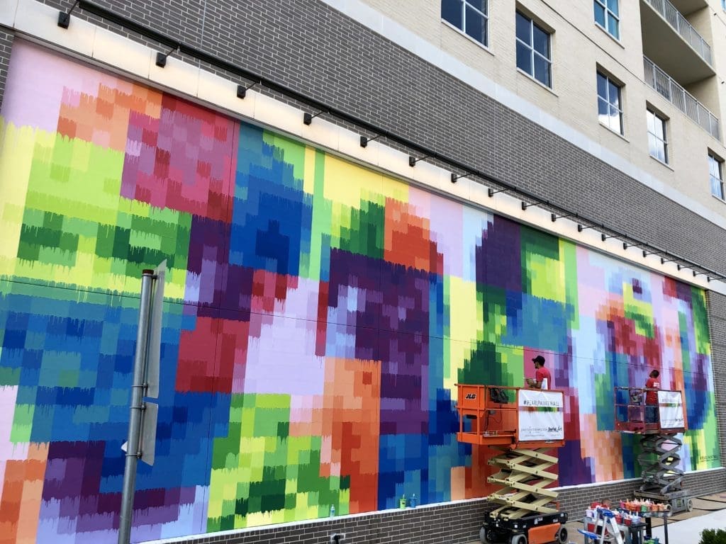 Five workers who represent the faces of Houston's diverse construction industry appear in pixelated form on "Pearl Paint Wall."