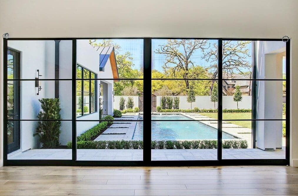 The living room at 112 Glenwood looks out onto the pool and inner garden in this home by Allan Edwards. Listed with Bice & Associates.