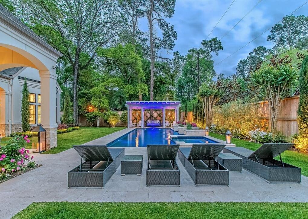 Graceful design, furnishings and landscaping combine for a masterful pool setting a 11611 Windy Lane.