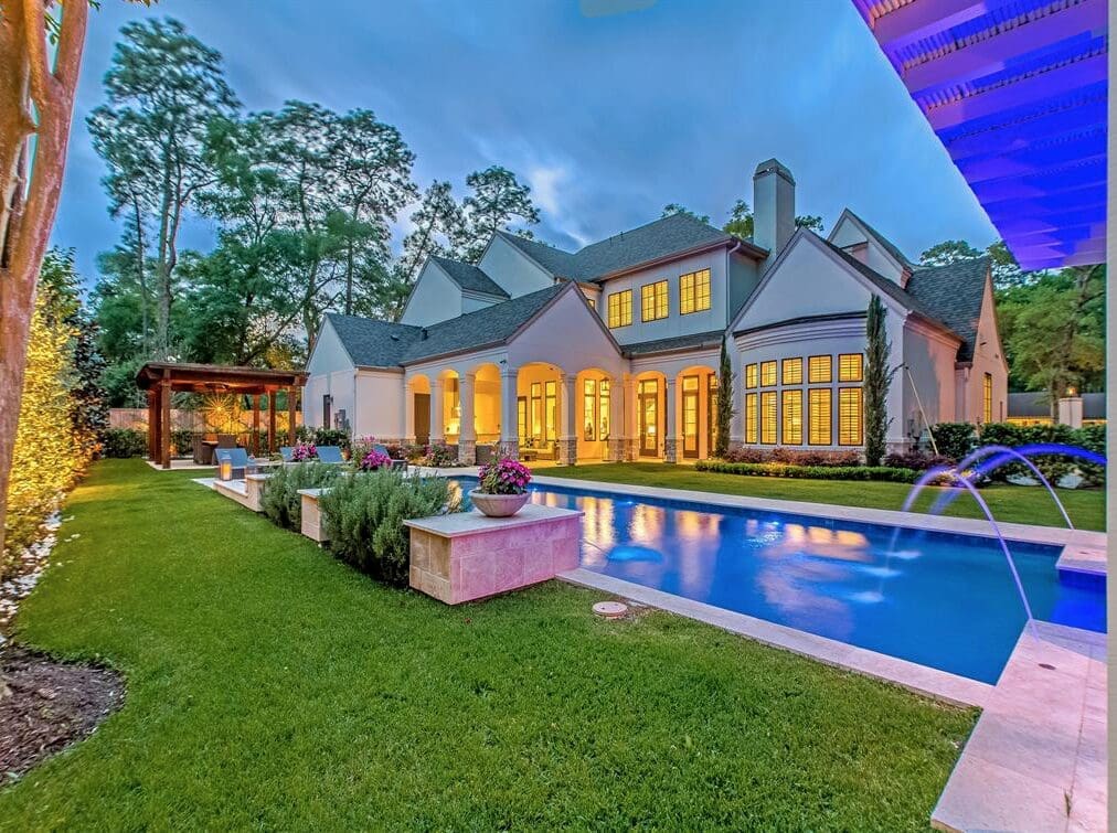 The pool at 11611 Windy Lane in Bunker Hill is a beauty that reflects the grandeur of the house by Frankel Building Group, Custom Design Pools.