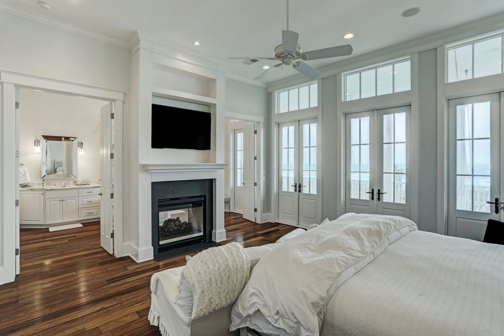 The master suite with high ceilings, hardwood floors and a gas fireplace beckons.  (Photo by TK Images)