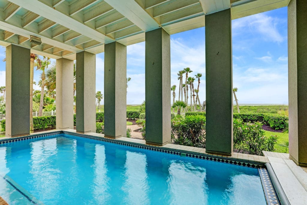 The loggia with swimming pool and view to the gulf is a special amenity at the Beachtown home.  (Photo by TK Images)