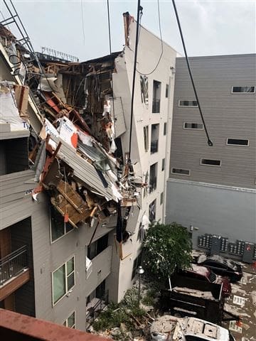 A crane collapsed into Elan City Lights apartments in Deep Ellum, killing a 29-year-old woman. Photo by Ryan Loewe via Twitter