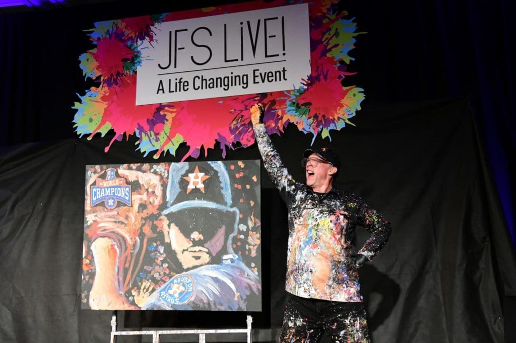 Speed painter Dan Dunn completes his painting at the JFS 106th anniversary gala. (Photo by Daniel Ortiz)