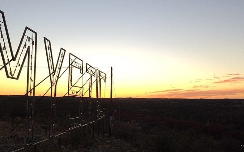 Camp Mystic's sign lights up at night for all to see.