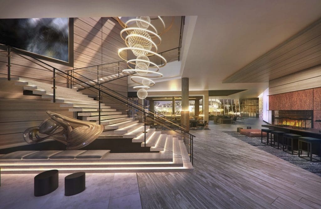 The lobby features an artsy chandelier and fireplace. 