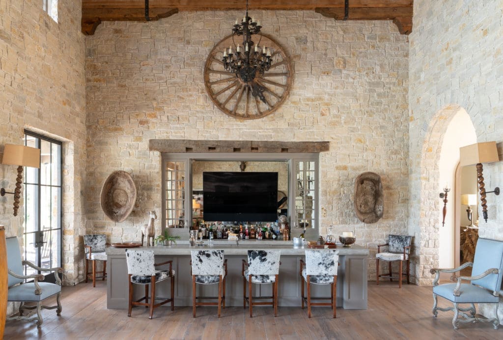 The bar area of the living room features hair-on-hide bar stools. (Photo by Michael Hunter)
