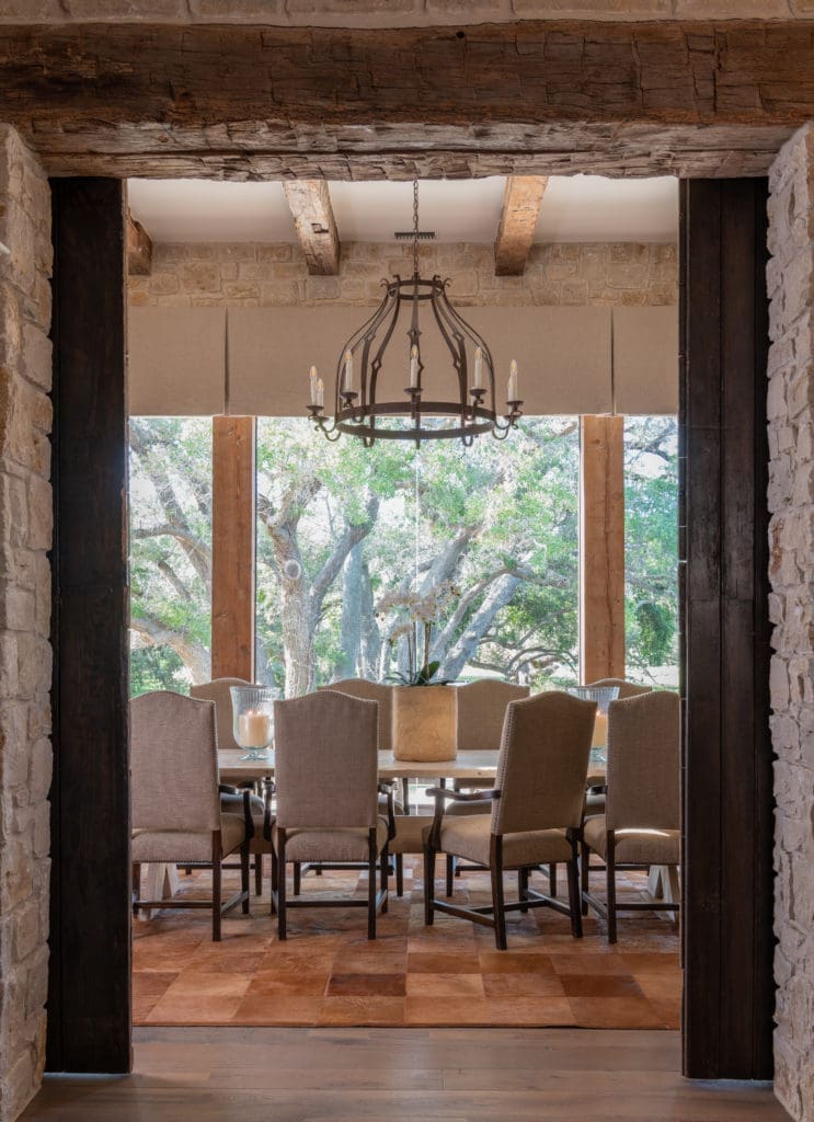 The formal dining room provides a view to the oak-shrouded grounds. (Photo by Michael Hunter)