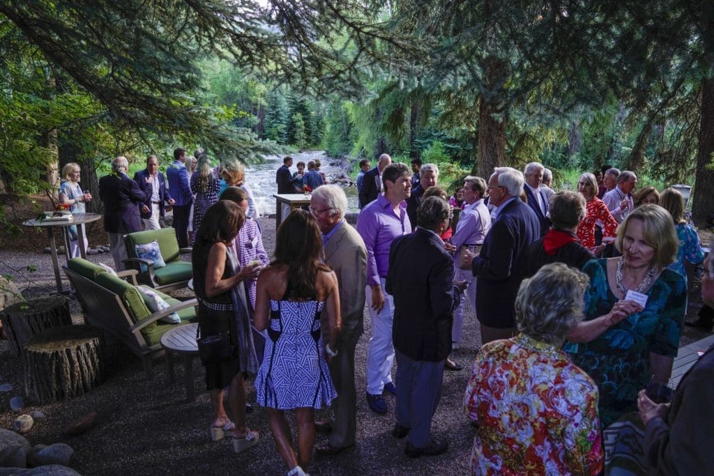 M.D. Anderson Cancer Center patrons party on the banks of the Roaring Fork River at a party hosted by Barbara and Gerald Hines. (Photo by Riccardo Savi)