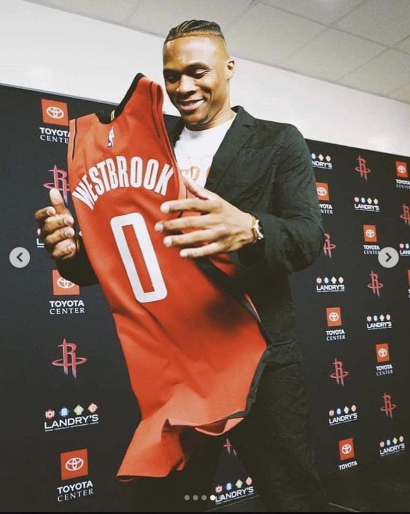Russell Westbrook seemed to get a kick out of his new reds Houston Rockets jersey. (@russwest44)
