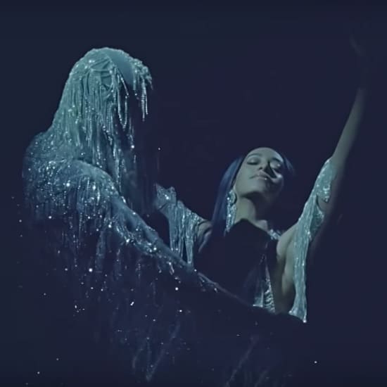 The face behind the crystal creature is revealed at the very end. 